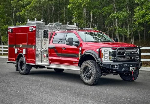 Front-left exterior view of the truck parked on roadway with side body profile.